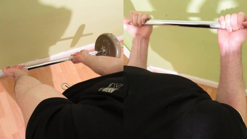 A man performing stand up straight bar curls for his biceps