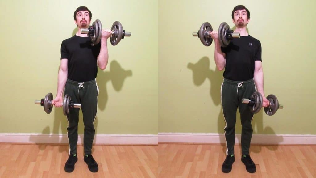 A man doing a standing dumbbell alternating curl for his biceps
