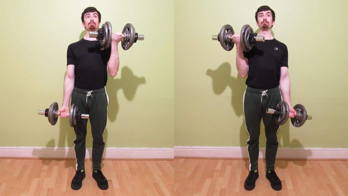 A man doing a standing dumbbell alternating curl for his biceps
