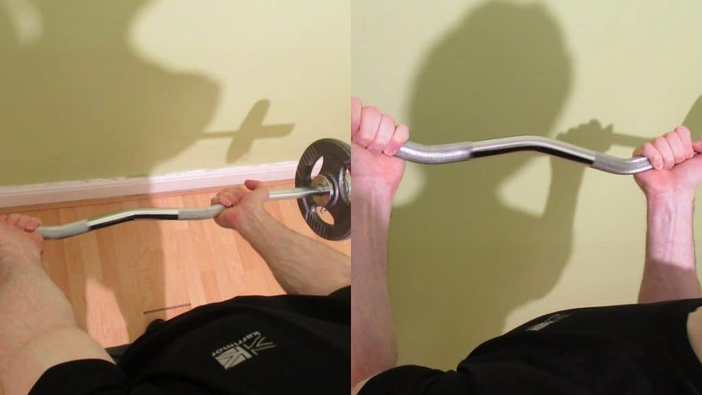 A man showing the proper standing EZ bar curl grip for working the biceps