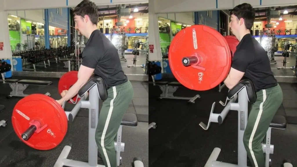 A man performing a standing preacher curl