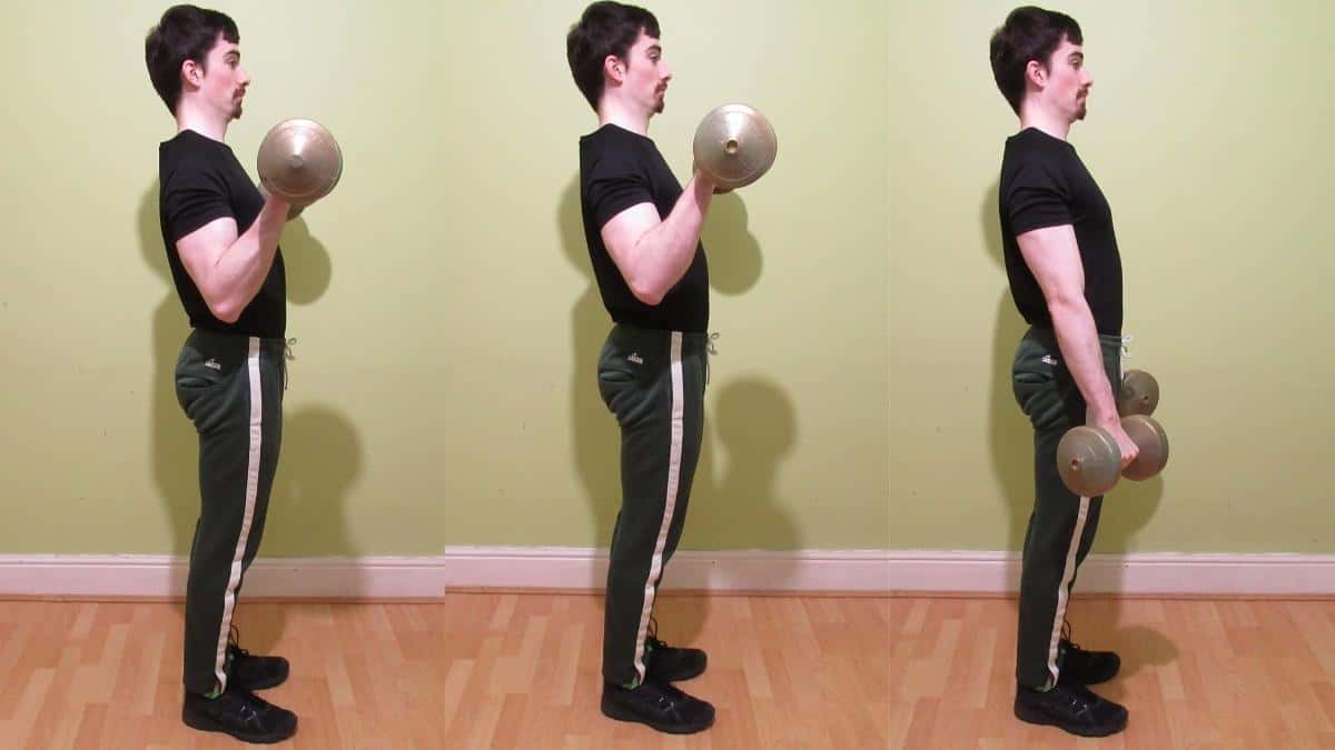 A man doing a standing Zottman curl with dumbbells
