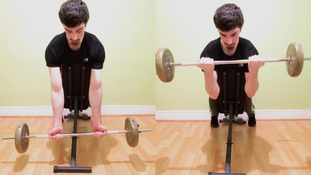 A man performing a straight bar spider curl