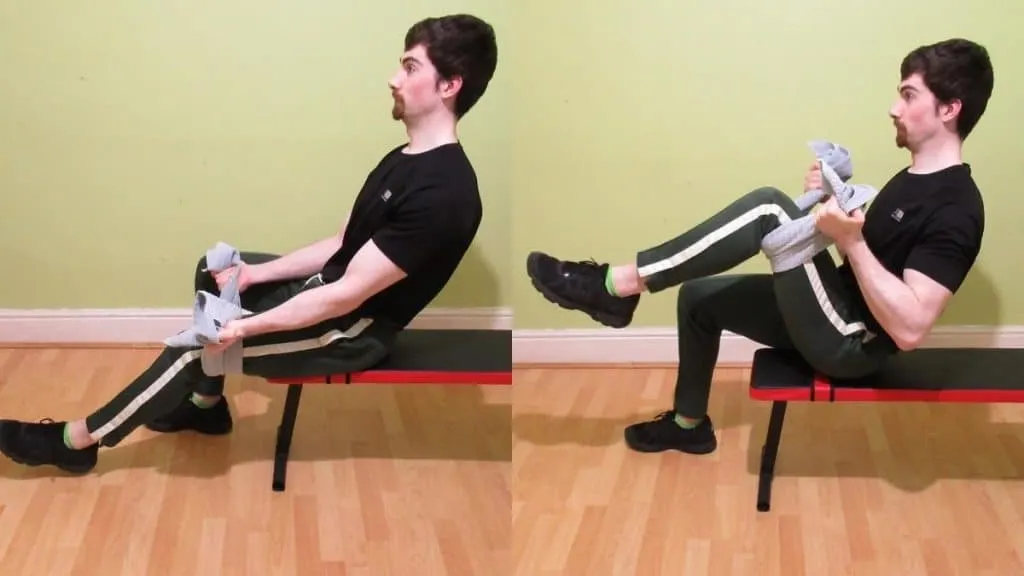 A man performing the towel curl exercise for his biceps