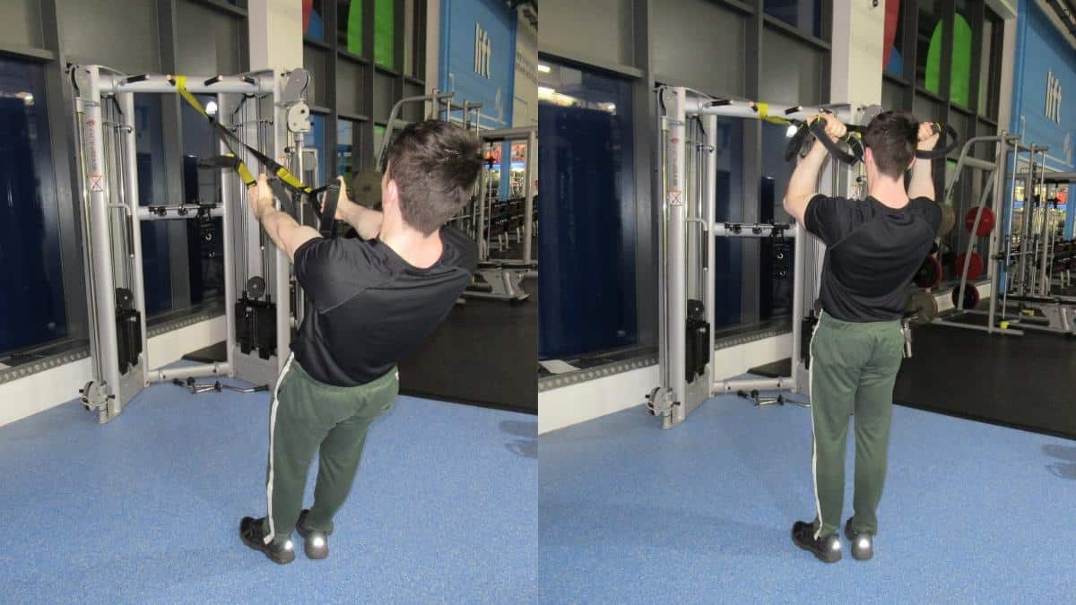 A man doing some TRX bicep exercises on a suspension trainer