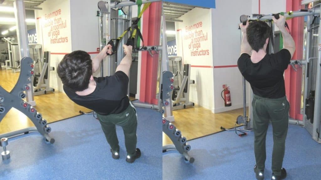 A man doing TRX hammer curls for his biceps