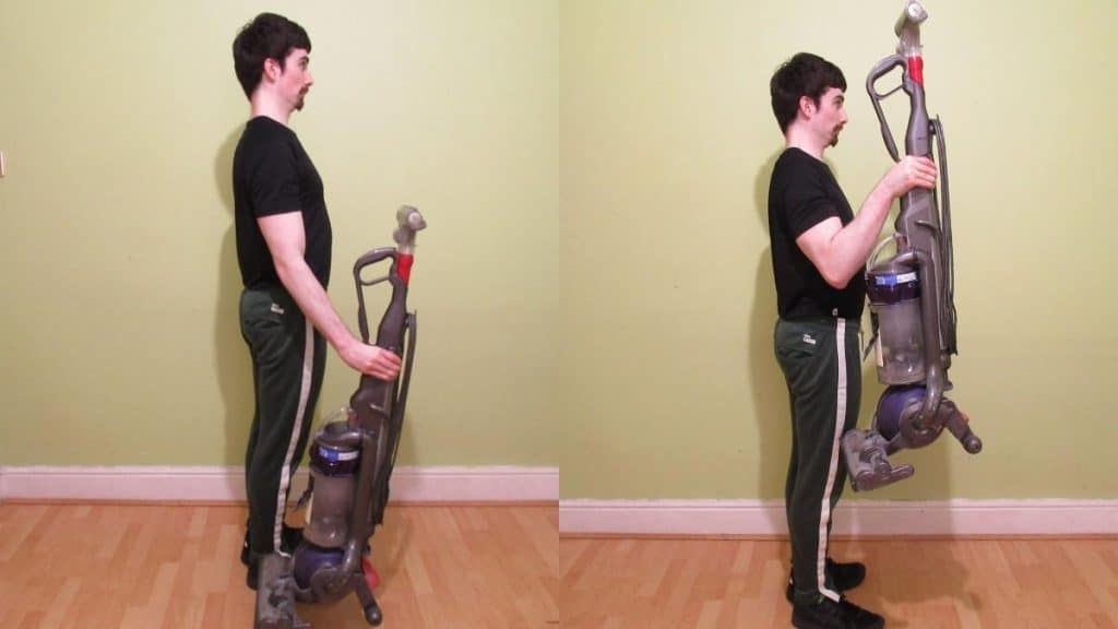 A man performing vacuum cleaner bicep curls
