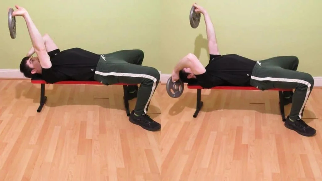 A man doing weight plate alternate skullcrushers