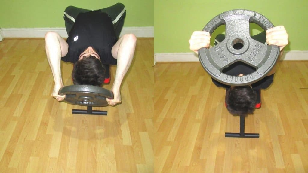 A man performing a weight plate skull crusher