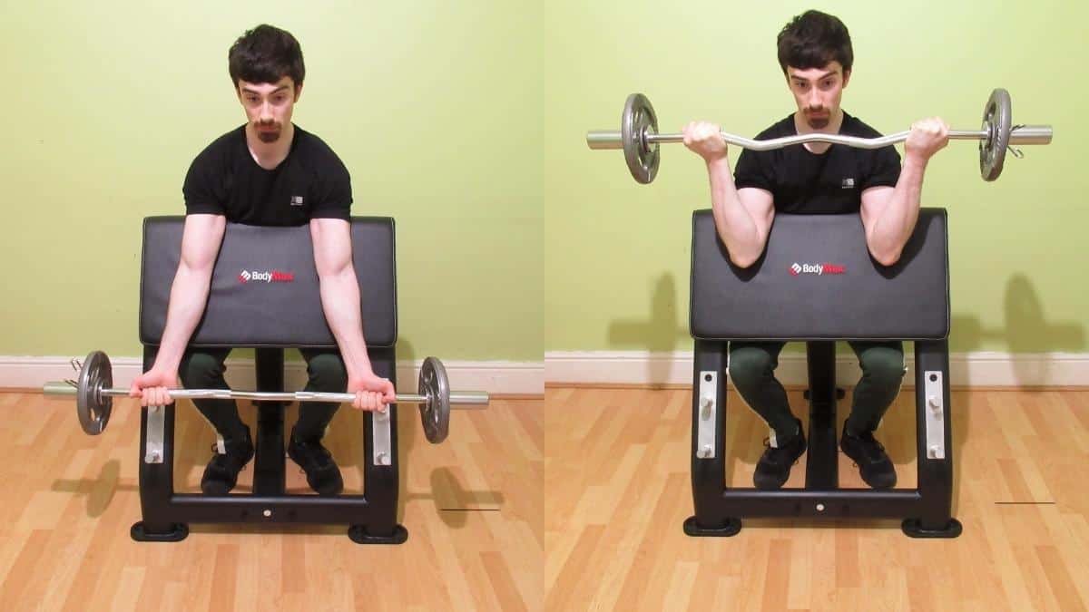 A man performing a wide grip preacher curl to work his biceps