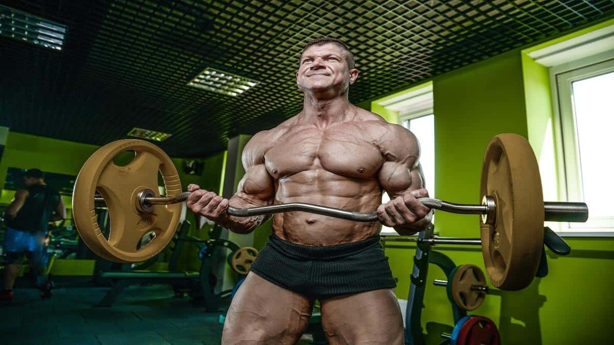 A muscular man attempting a world record bicep curl