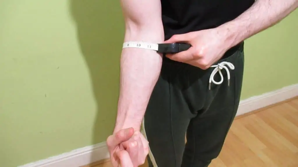 A man flexing his 11 inch forearm