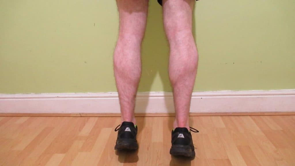 A man flexing his 15 inch calves