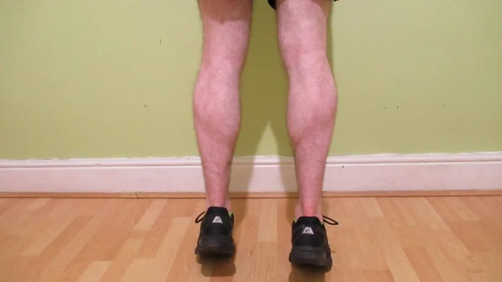 A man flexing his 15 inch calves