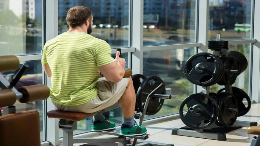 A bodybuilder working out his 20 inch calf muscles