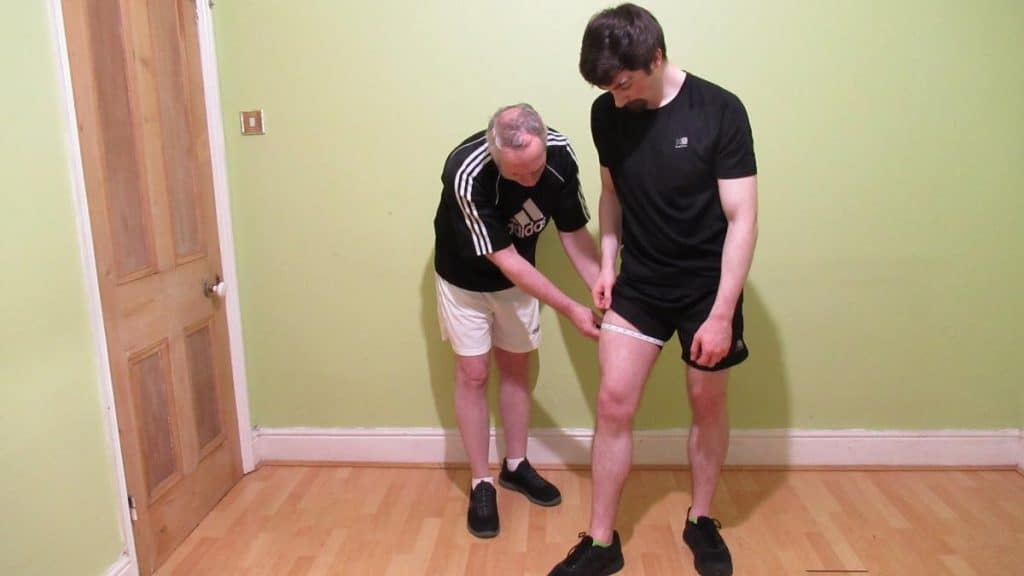 A man getting his 22 inch thigh circumference measured