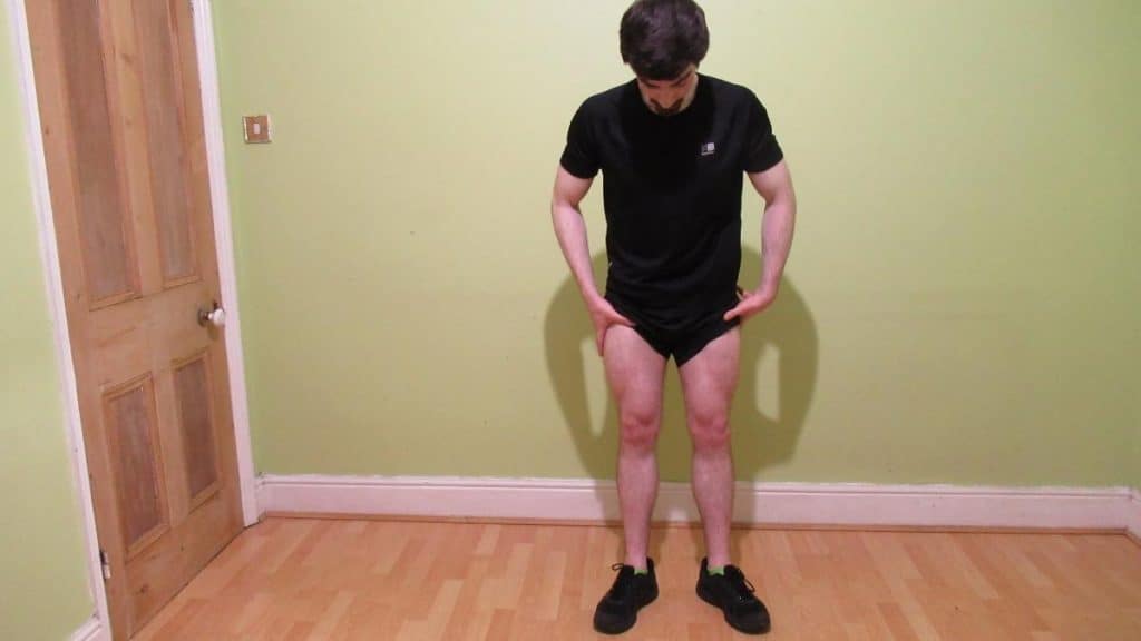 A man flexing his 24 inch quads