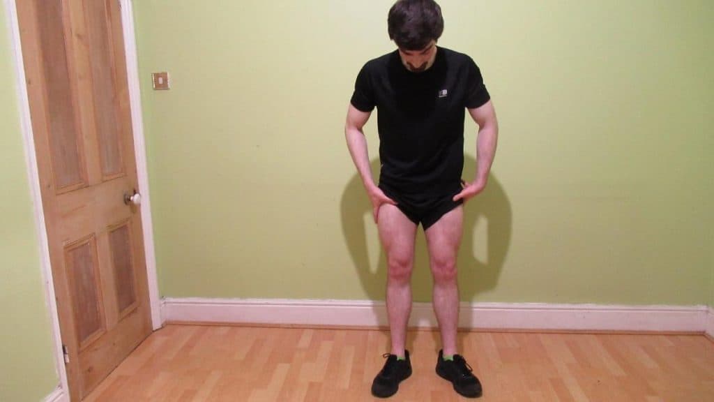 A man flexing his 25 inch quads