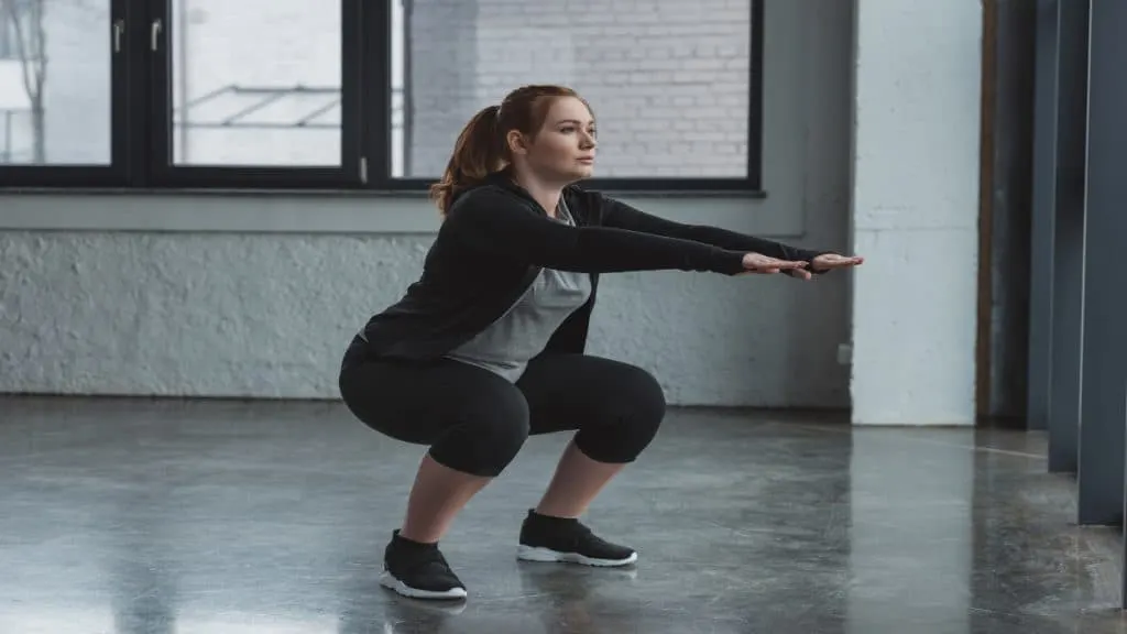 A woman working out her 26 inch thighs with squats