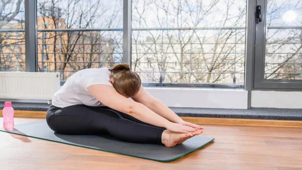 A female stretching her 28 inch legs