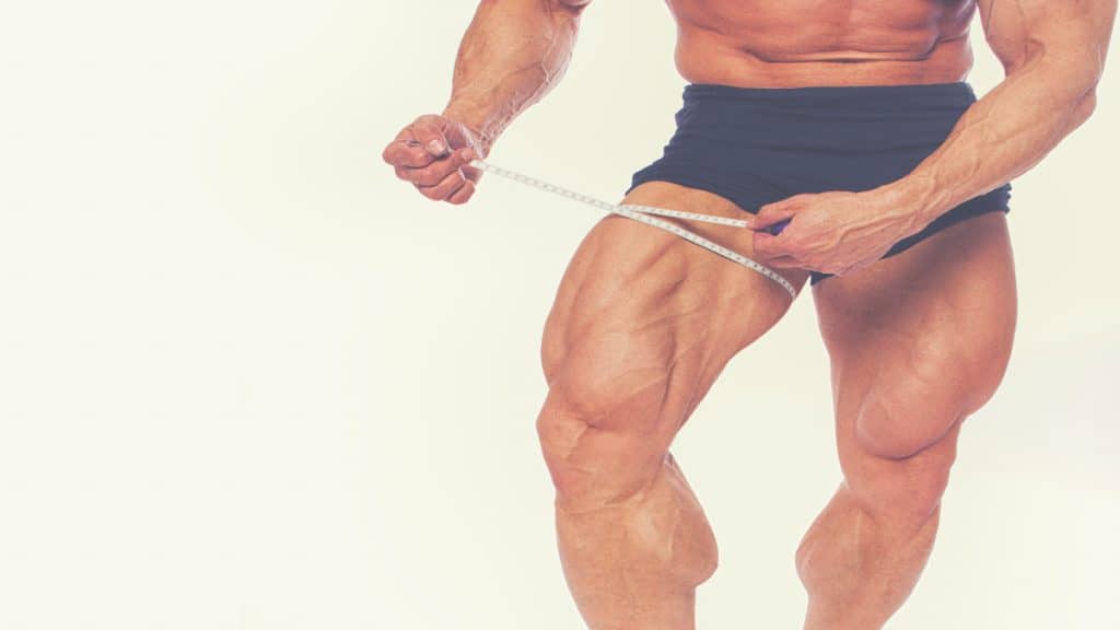 A bodybuilder flexing his 29 inch quads