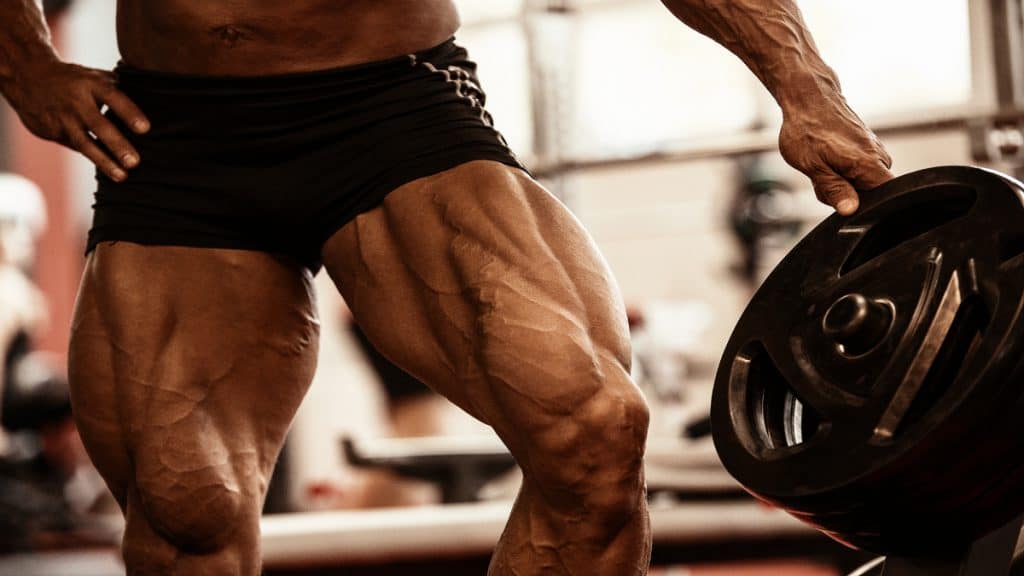 A bodybuilder flexing his 30 inch quads