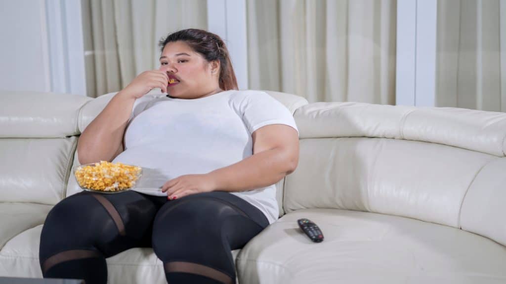 A woman with a 32 inch thigh circumference sat on the sofa