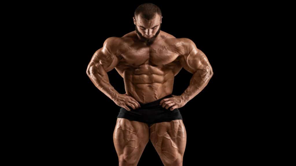 A bodybuilder looking at his 34 inch quads