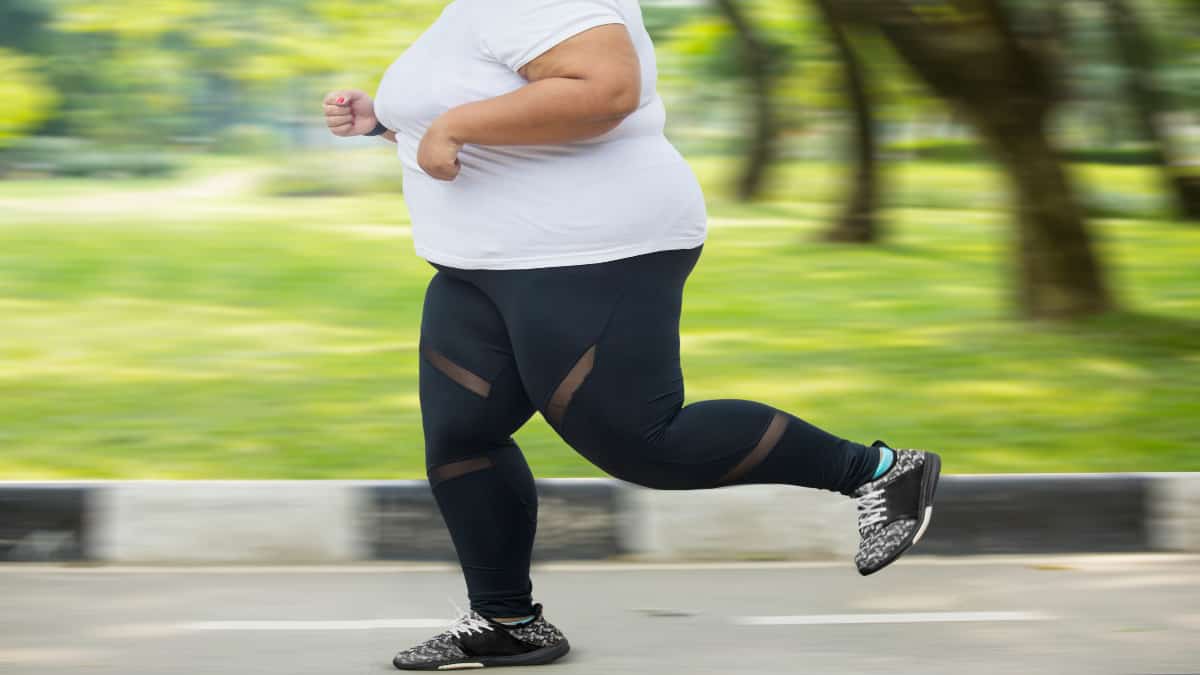 An obese woman with 35 inch thighs running outside