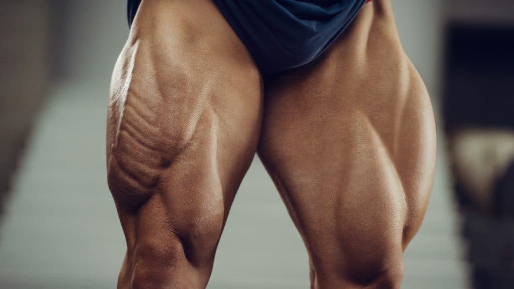 A bodybuilder flexing his 40 inch quads