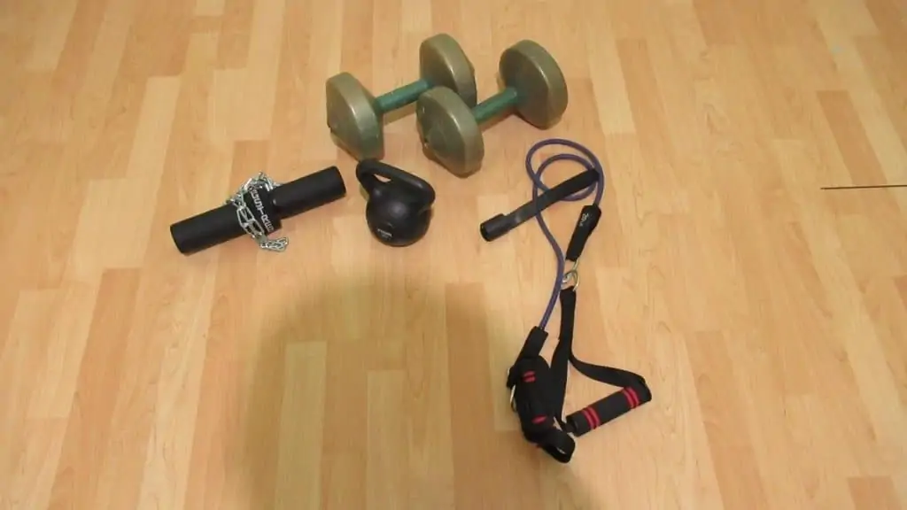 The equipment needed for at home forearm workouts; dumbbells, bands, wrist roller