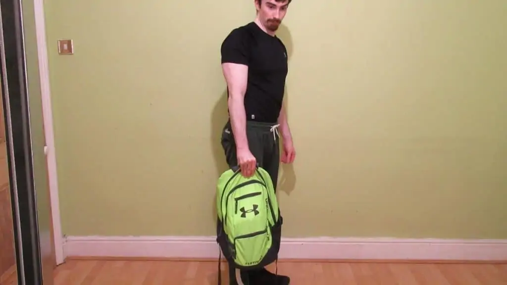 A man performing backpack holds for his forearms