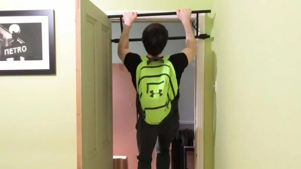 A man doing some backpack pull up holds