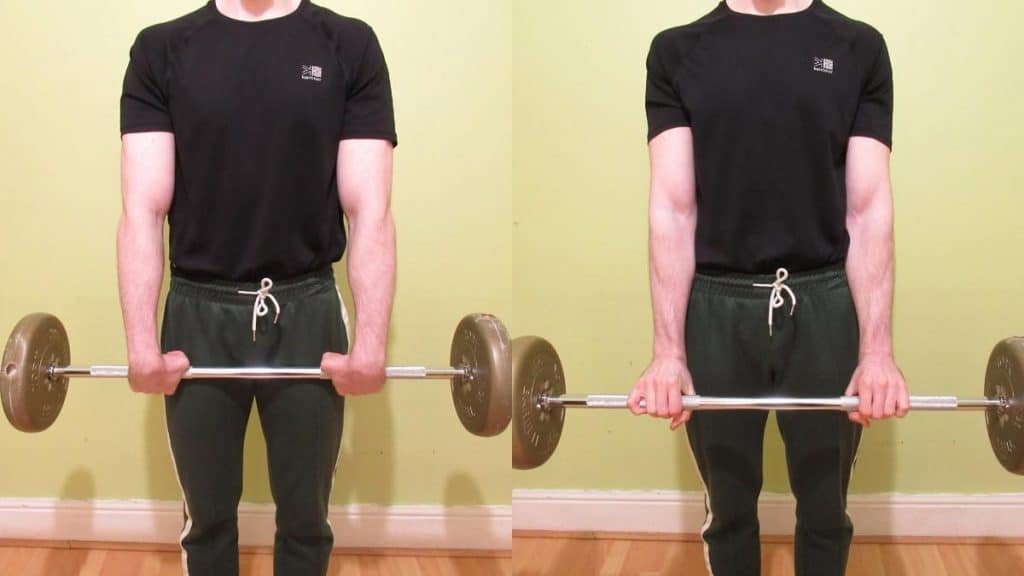 A man doing some barbell standing forearm curls