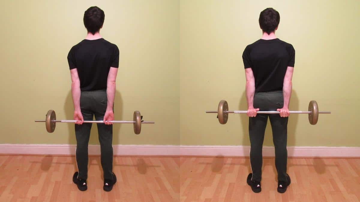 A man performing a behind the back barbell wrist curl to train his forearms