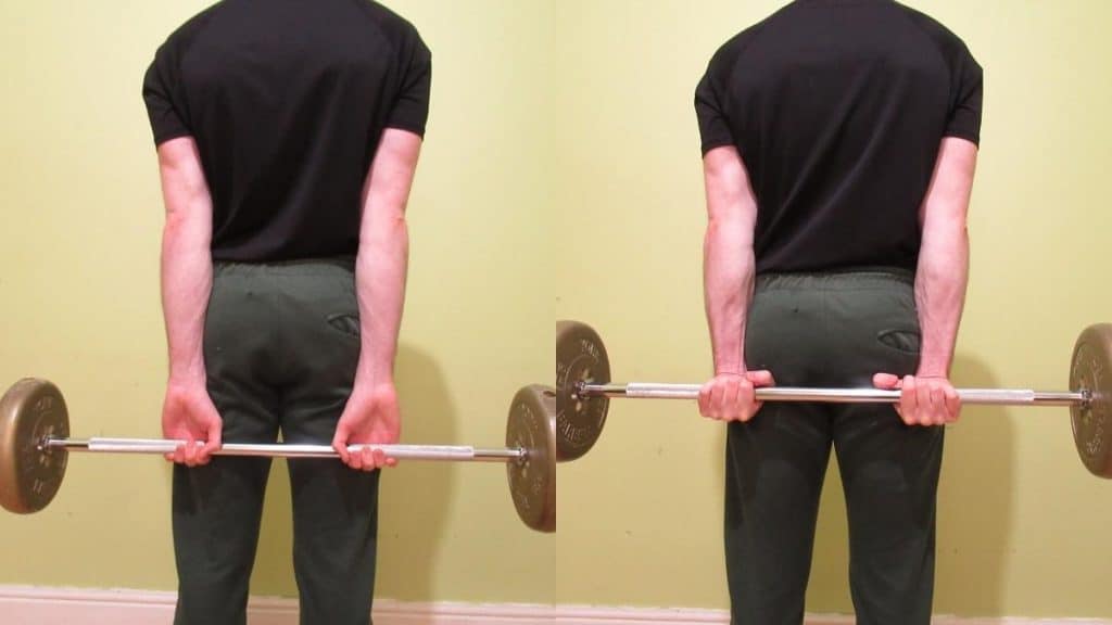 A man performing a barbell behind the back wrist curl for his forearms