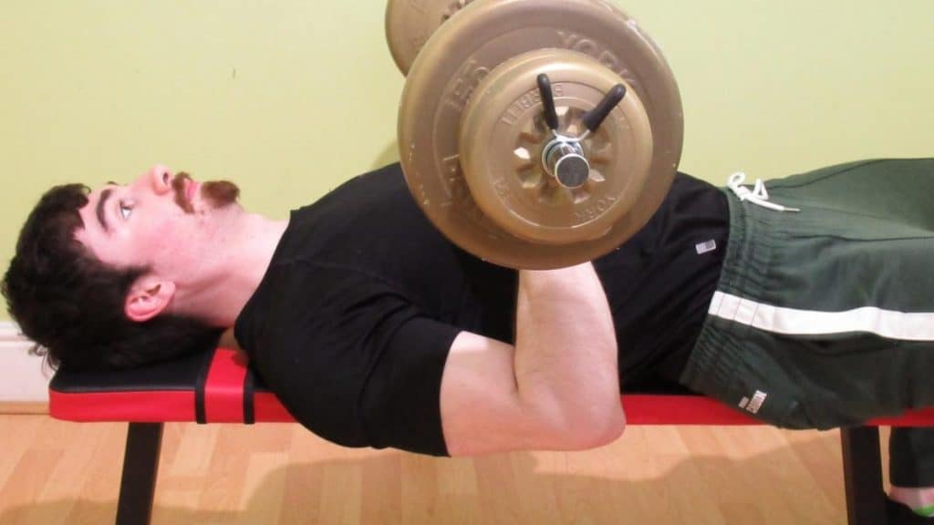 A man demonstarting how the forearms are used during the bench press