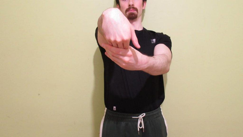 A man demonstrating the best forearm extensor stretch for loosening up your muscles