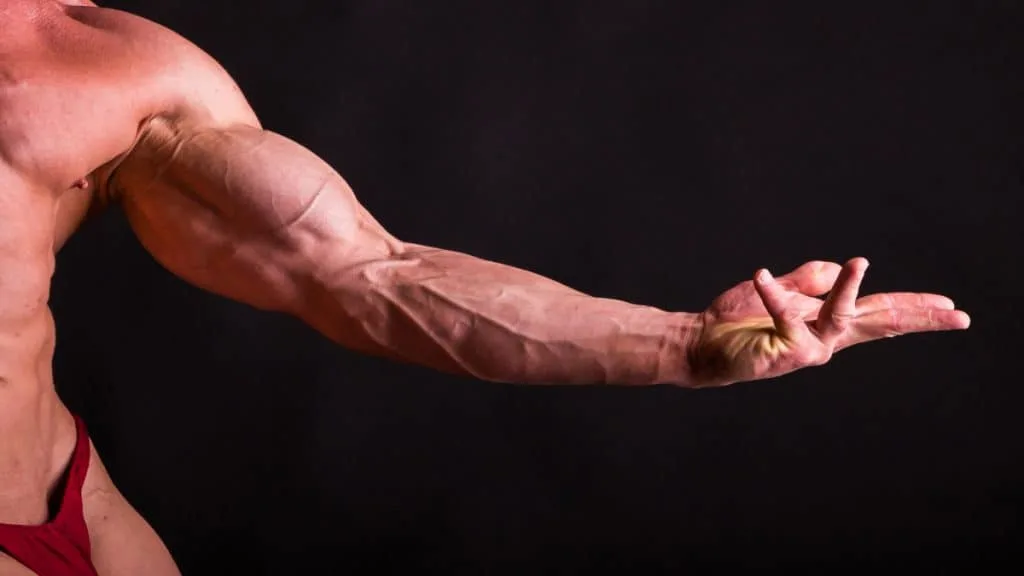 A bodybuilder posing and flexing his arm