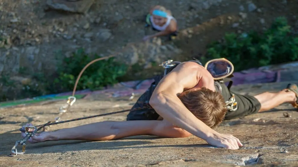 A man getting a good forearm workout while rock climbing