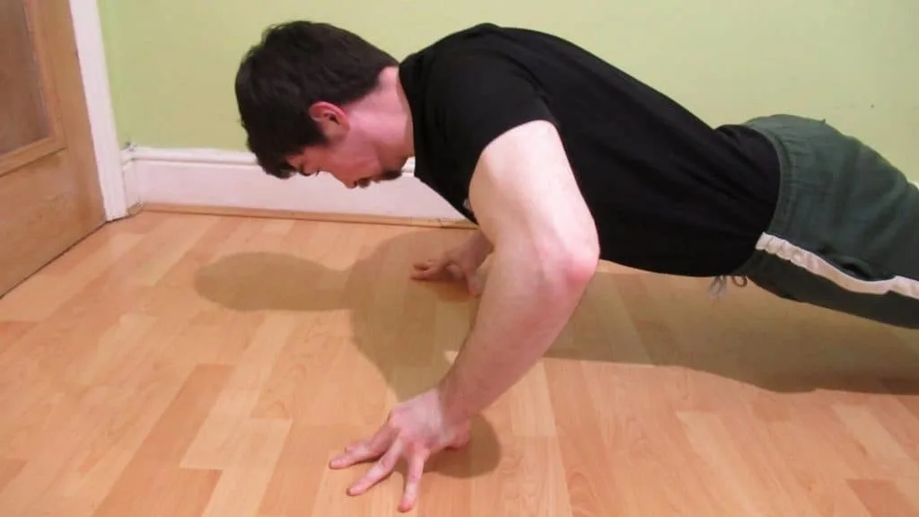 A close up of a man's forearms during push ups