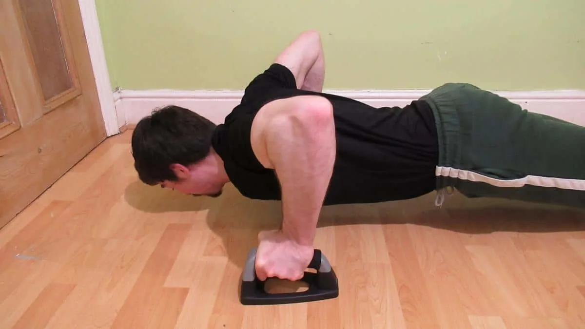 A man demonstrating how pushups work the forearms