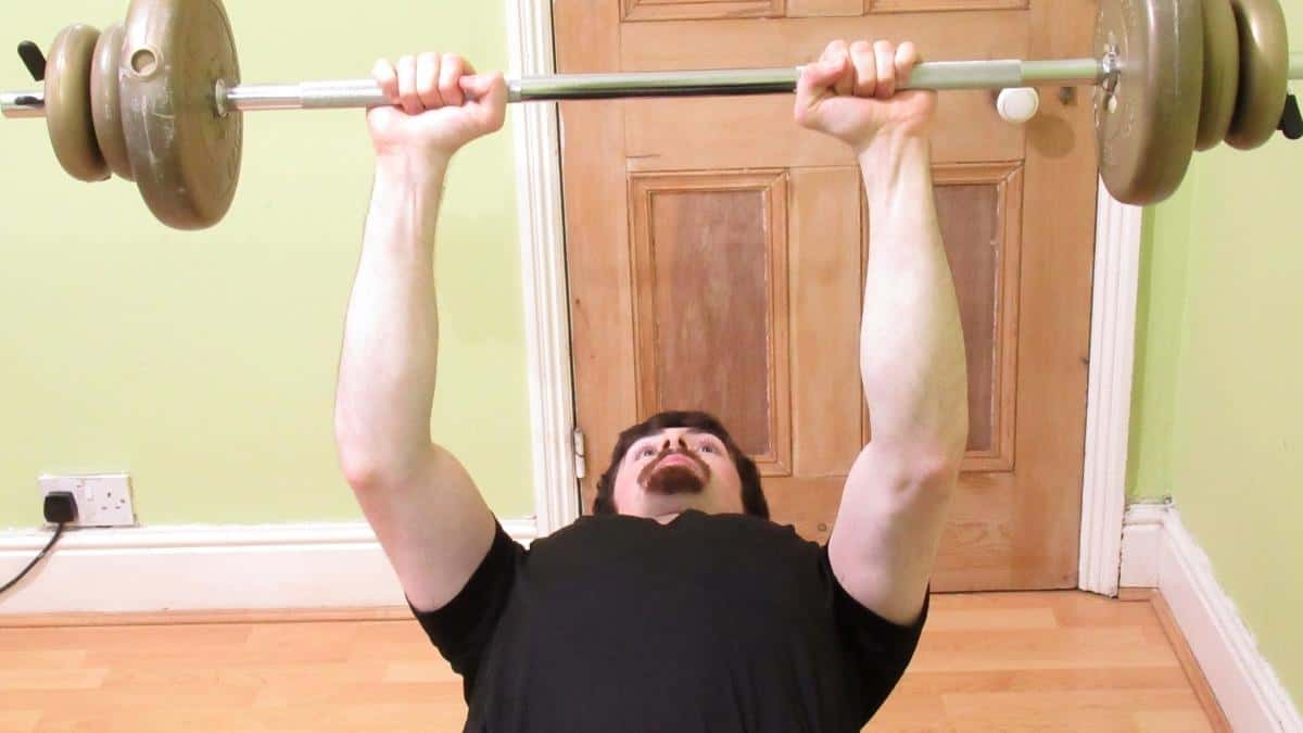 A weight lifter showing how bench press works your forearms