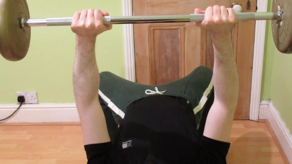 A man showing how the bench press can work your forearms