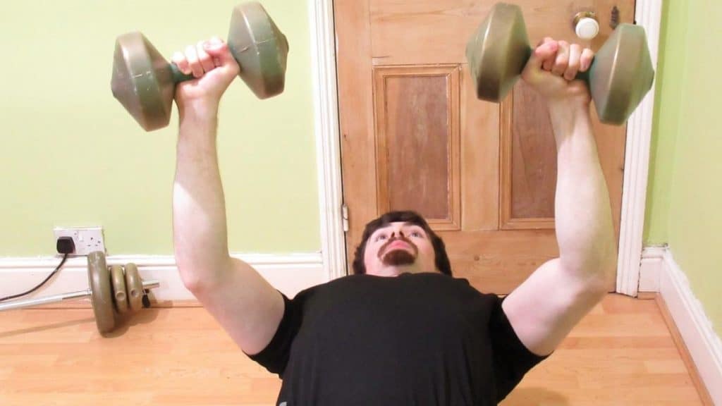 A weight lifter showing how bench pressing works the forearms