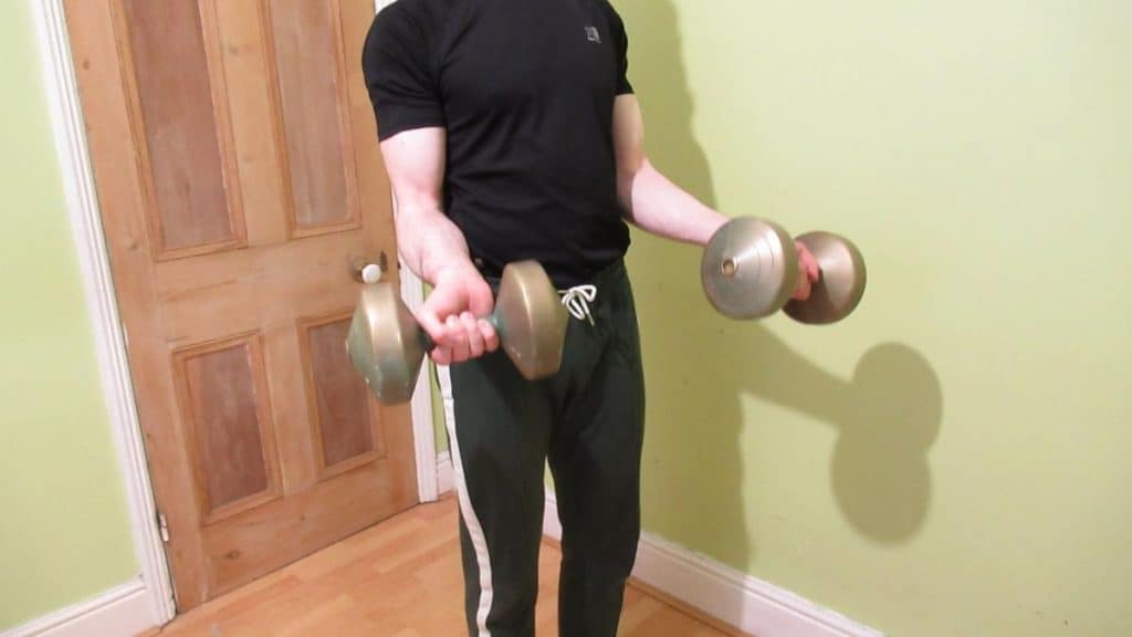 A man showing how bicep curling can work your forearms