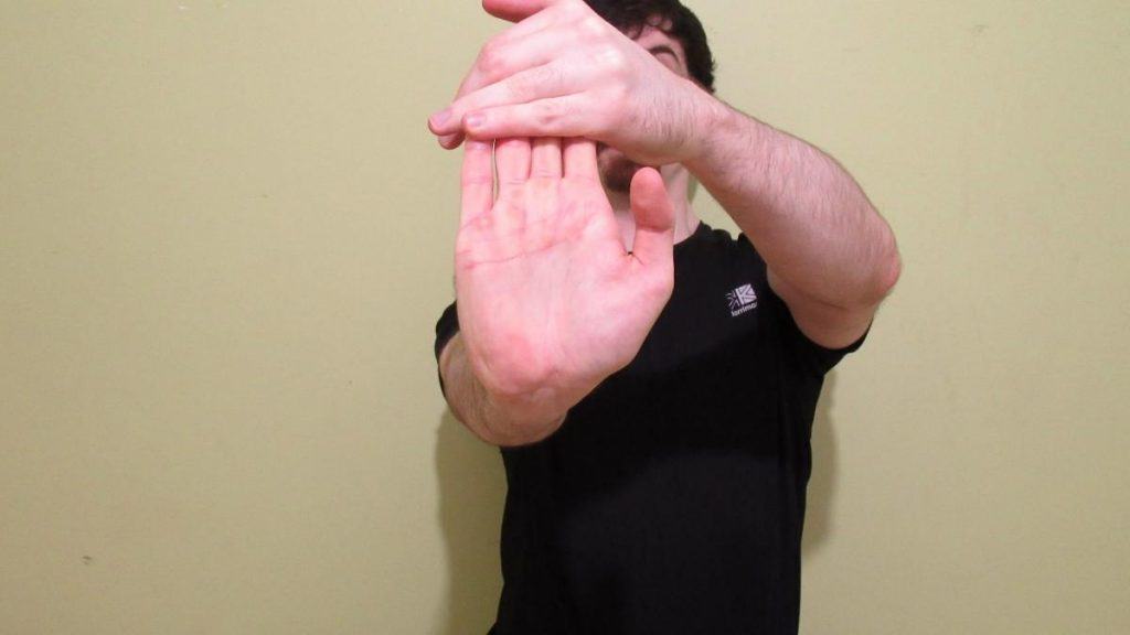 A man doing a flexor carpi radialis stretch