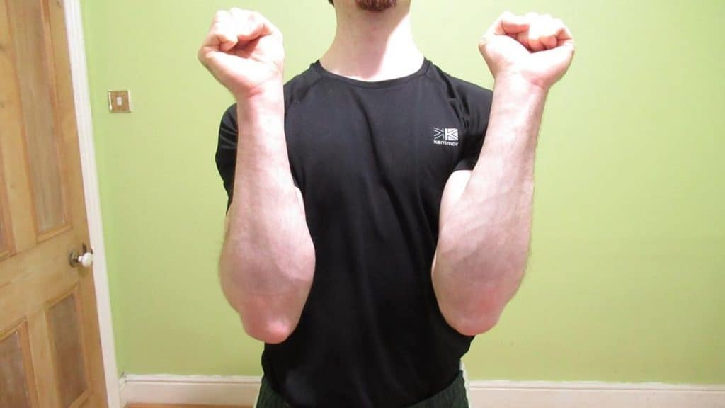 A man showing his lower arms after doing some forearm and wrist exercise
