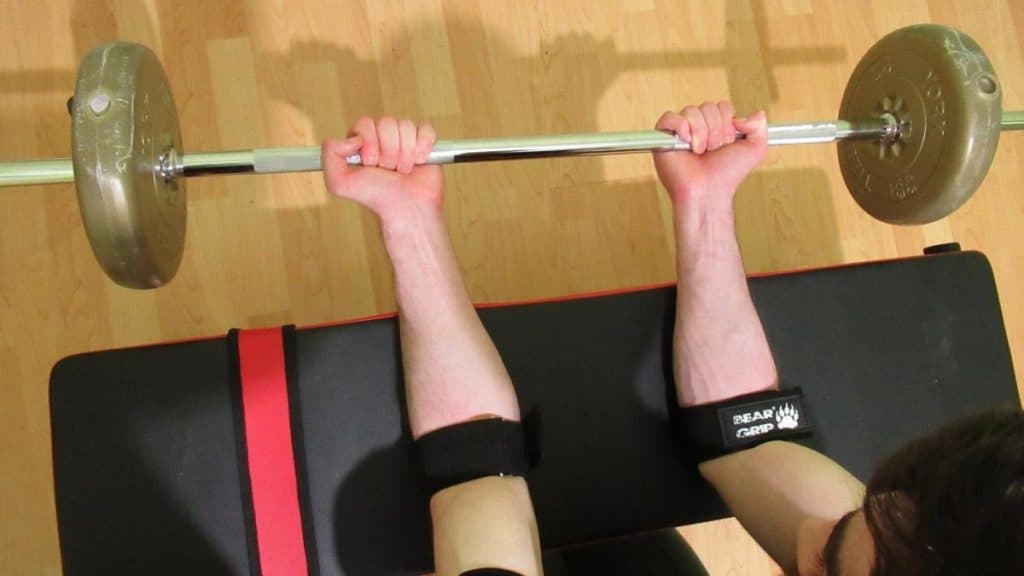 A weight lifter performing forearm blood flow restriction training