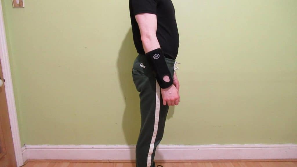A man wearing a forearm brace for tennis elbow